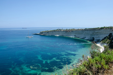 Fototapeta na wymiar Munxar path. Landscape with Mediterranean Sea with blue water and white rocks in Malta near Marsaxlokk, Saint Peter Pool.