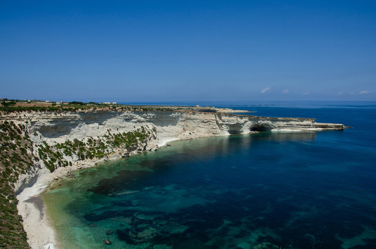 Munxar path. White rocks with blue water in Malta near Marsaxlokk, Saint Peter Pool.