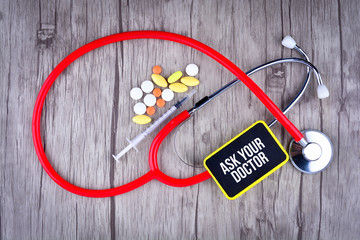 Pills, Syringe and Stethoscope with text Ask Your Doctor