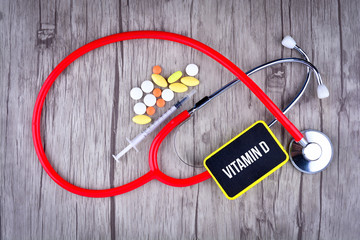 Pills, Syringe and Stethoscope with text Vitamin D