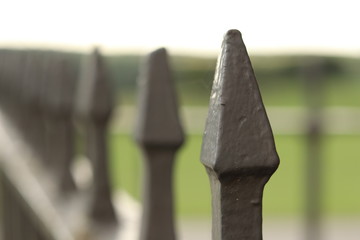A spiked metal fence surrounding a Yorkshire country house. 
