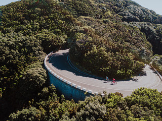 Aerial view of cyclists riding bicycle on road
