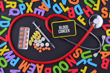 Pills, Syringe and Stethoscope with alphabet and text Blood Cancer