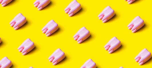 Teeth pattern on yellow bright background. Top view.