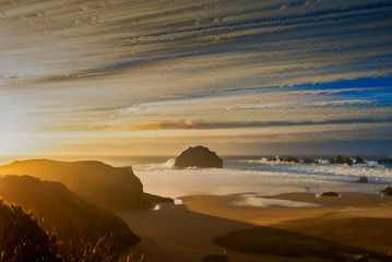 Abstract and artsy image of clouds streaking over Face Rock in Bandon, Oregon,, achieved by...