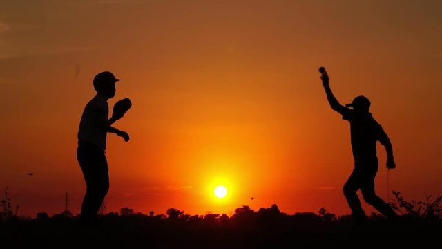 Silhouette baseball, two men were practicing throwing a baseball and getting together footage slow motion