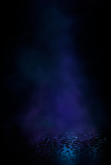 Empty street scene background with abstract spotlights light. Night view of street light reflected on water. Rays through the fog. Smoke, fog, wet asphalt with reflection of lights. 