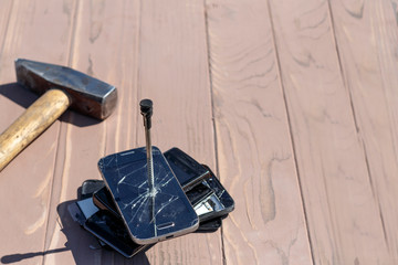 daylight. hammer hit on the phones. in one of them there is a metal nail