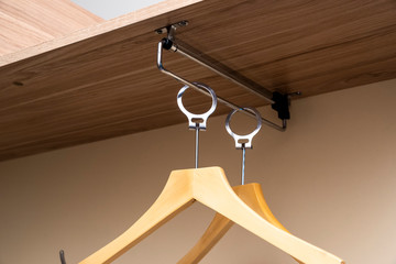 clothes hangers in the closet close-up, on a sliding wardrobe system