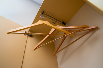 three wooden clothes hangers in the closet