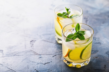 Delicious drink with lemon, lime and mint on the table with copy space