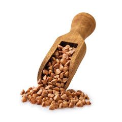 Obraz premium Wooden scoop full of buckwheat groats isolated on white background