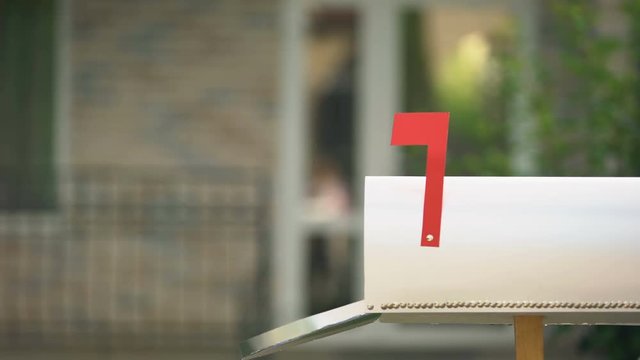 Man receiving dollars from mailbox, using transfer service, financial operations