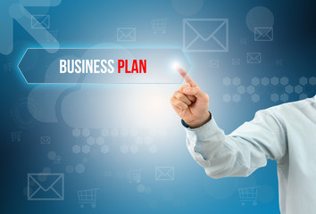 business man touch a button on an imaginary screen with text BUSINESS PLAN