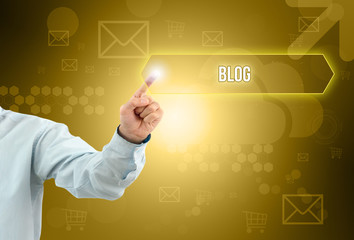 Business man touch a button on an imaginary screen with text BLOG