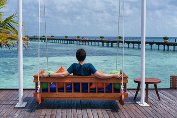 Man seated in a bench in a Maldives Islands Resort