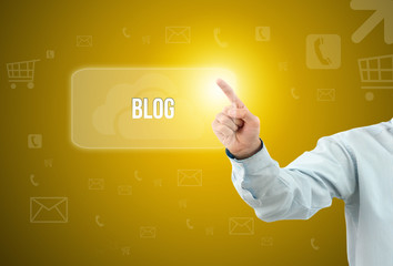 Business man touch a button on an imaginary screen with text BLOG
