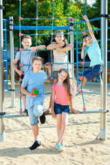 Fototapeta na wymiar Five kids posing at the playground together