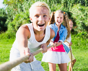 Children playing tug of war outdoors