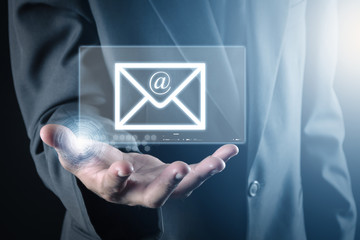 hand holds a virtual postal envelope, concept of email, internet and networking