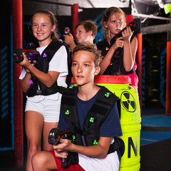 Happy teenagers with laser guns