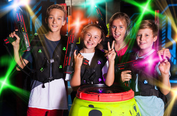 Fototapeta na wymiar Teen kids with laser guns
