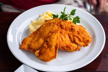 Wiener schnitzel on white plate.