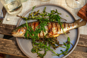 Grilled trout with herbs.