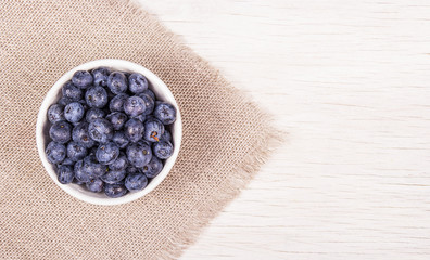 Blueberries in white bowl. Copy space. Top view