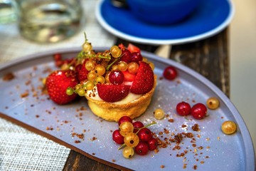 Cupcake with many fruit berries.