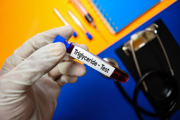 Triglyceride - Test with blood sample. Top view isolated on color background. Healthcare/Medical concept