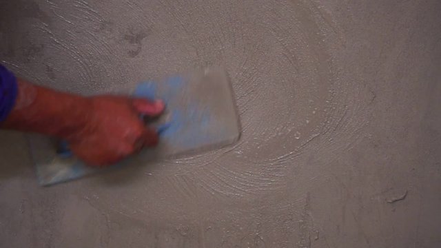Construction worker finishing a wall fooage slow motion