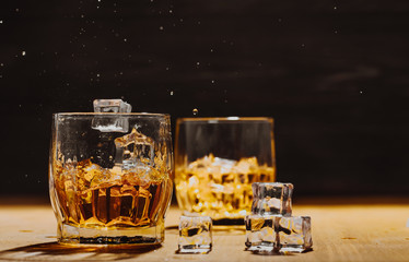 Still life. Whiskey in to glass. Wooden table