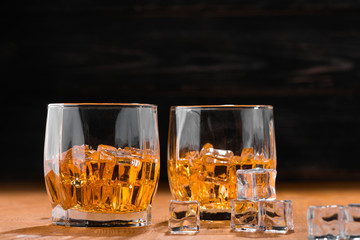 Still life. Whiskey in to glass. Wooden table