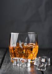Still life. Whiskey in to glass. Wooden table