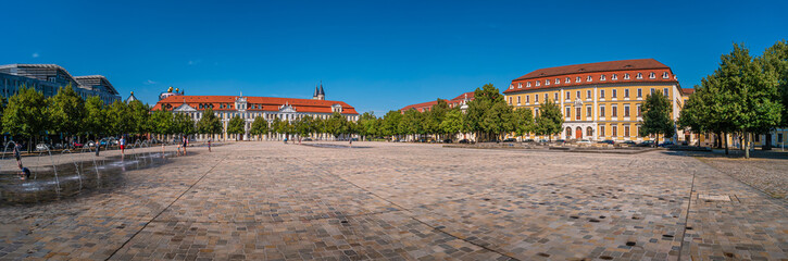 Panoramic view of major Dome square with fountains by Cathedral and Government Office in Magdeburg, Germany, at sunny day and blue sky during Summer