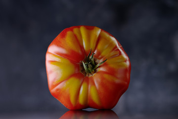 tomato front view on dark background