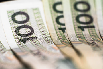 Polish Zloty banknotes (PLN) composition - Closeup on stack 100 PLN banknotes. Macro shot. Business background