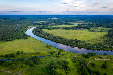 Fototapeta na wymiar aerial landscape of winding river Klyazma in green field, top view of beautiful nature texture from drone/ Vladimir city Russia