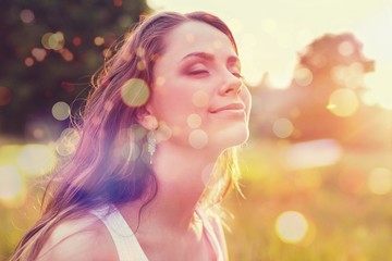 Young woman on field under sunset light