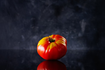 tomato front view on dark background