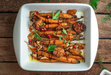 Homemade roasted carrots with garlic and oregano, copy space