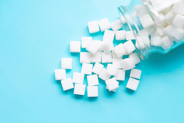 Cubes of sugar on a blue background.