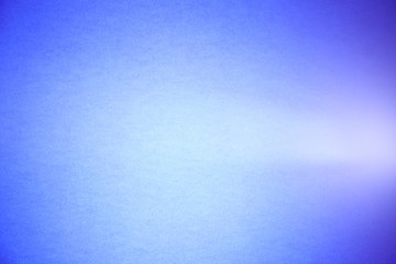 A light purple ray cuts through the textural and semi-blurred light blue background