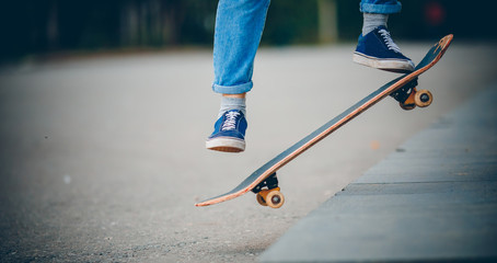 Fototapeta na wymiar Skateboard man in shoes and jeans getting ready to jump kickflip olli from steps
