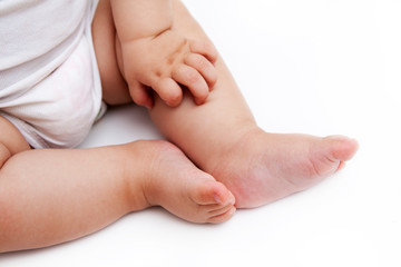 Obraz na płótnie Canvas little plump legs of an infant on white background