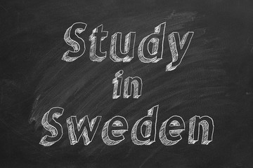 Hand drawing "Study in Sweden" on black chalkboard. 