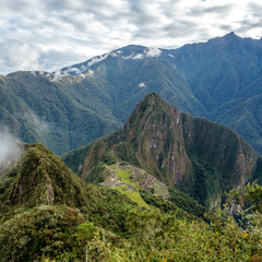 Fototapeta premium Huayna Picchu, or Wayna Pikchu, mountain in clouds rises over Machu Picchu Inca citadel, lost city of the Incas