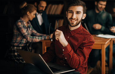 officer of the company with laptop on the background of business