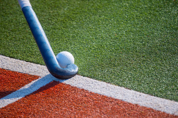 Field Hockey Stick and Ball on fake Grass With Copy Space.